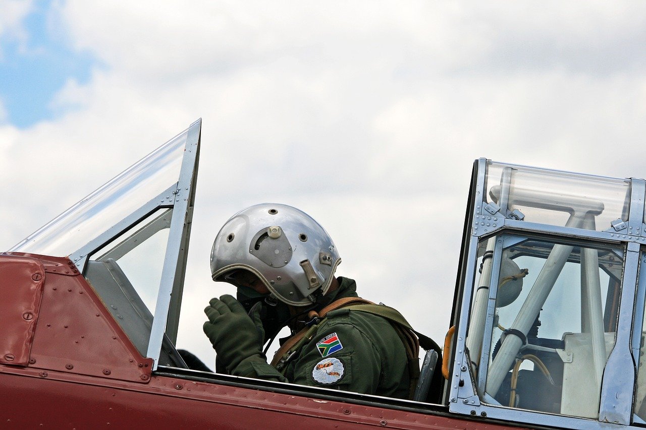 services-01 harvard pilot, adjusting oxygen mask, flying suit, cockpit, preparing for takeoff, south african air force museum, aviation